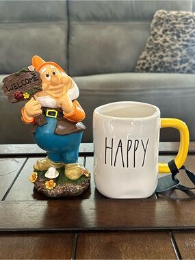 Rae Dunn White Ceramic 'HAPPY' Mug with Disney Happy figurine.